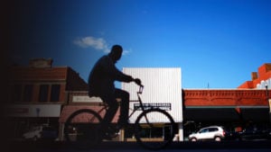 Man riding his bike through downtown Ponca City, Oklahoma.